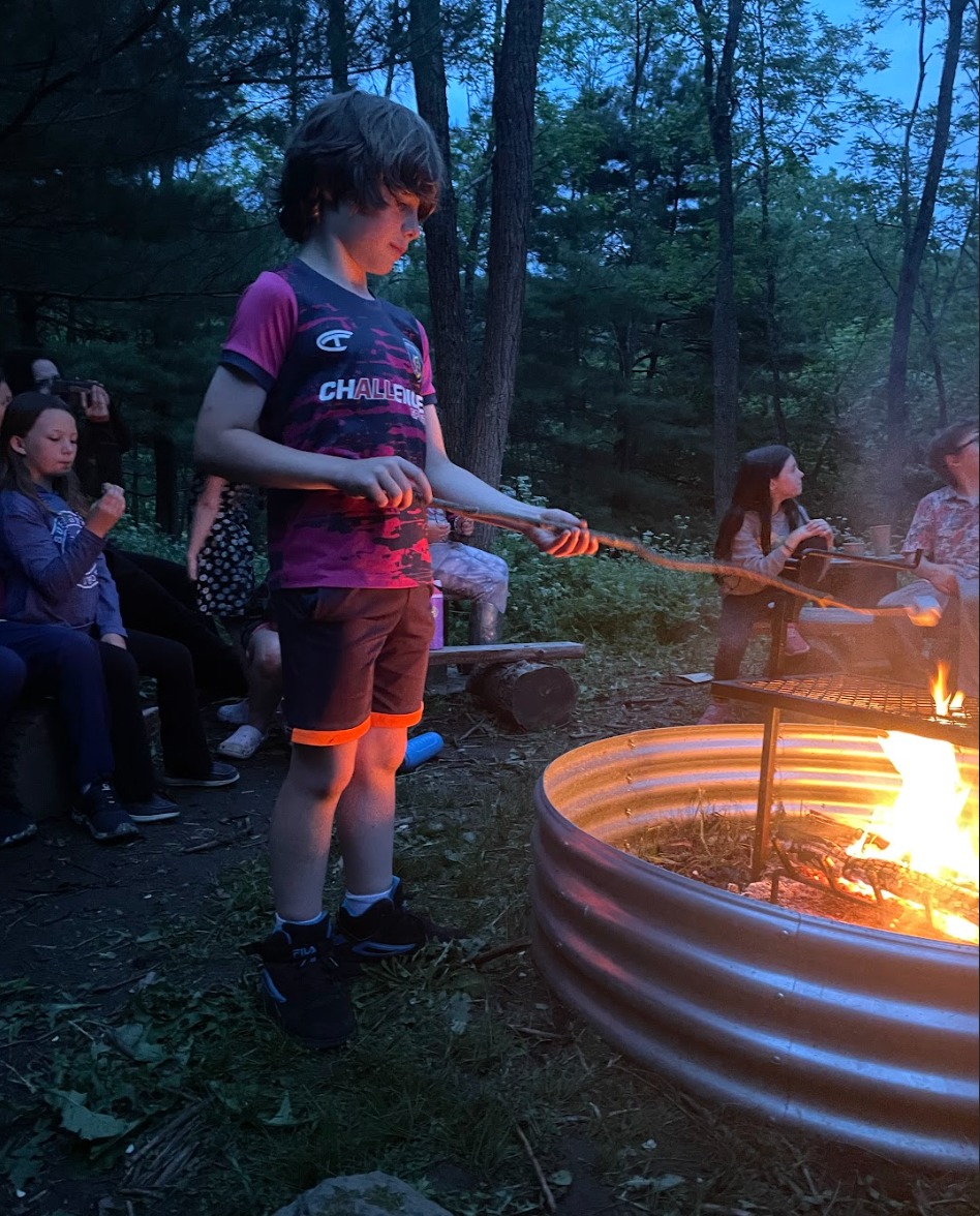 kid in front of a campfire.